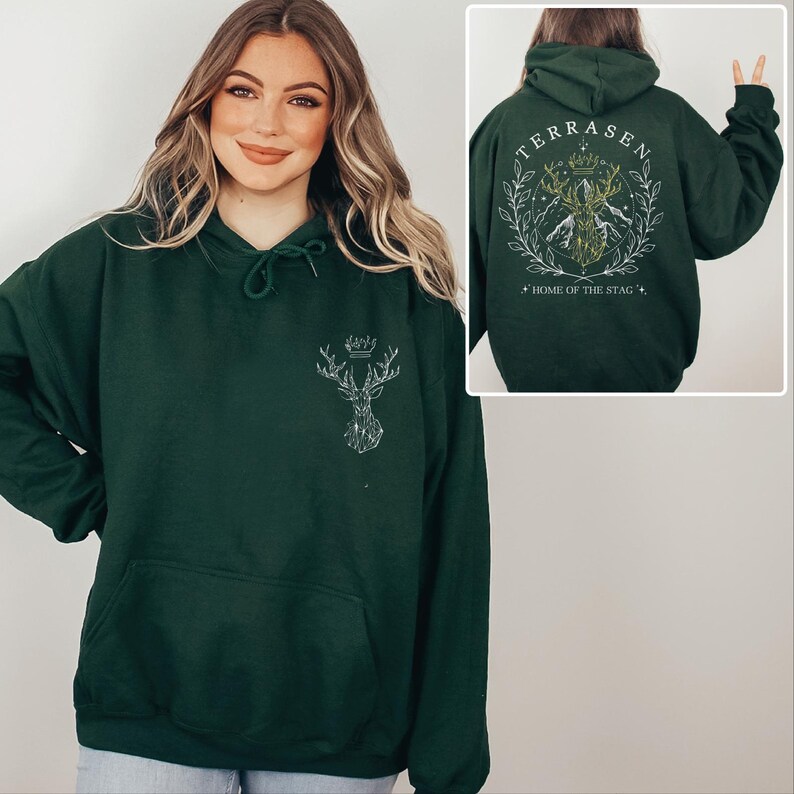 A woman wearing a green hoodie with a design on the back.
