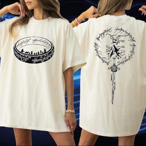 A woman wearing a white t-shirt with a graphic design on the front and back.