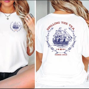 a woman wearing a white shirt that says sailing the sea