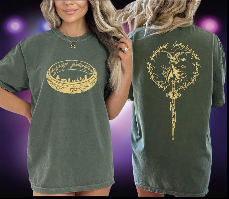 A woman wearing a green t-shirt with a graphic design on the front and back.