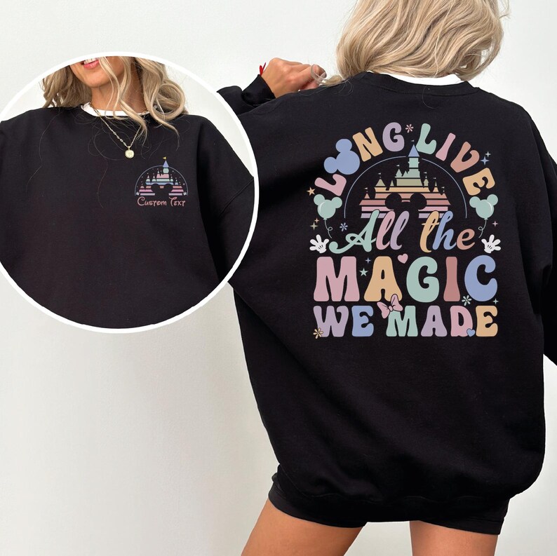 A woman wearing a black sweatshirt with a colorful graphic design on the back.