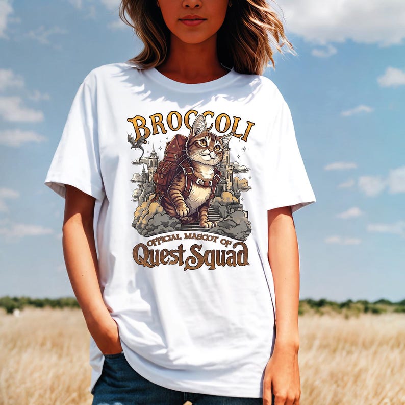 a woman wearing a white broccoli shirt in a field