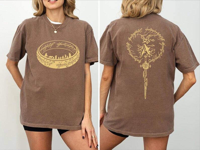 a woman wearing a brown t-shirt with a graphic design on the front and back.