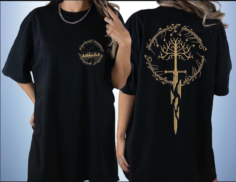 two black t-shirts with gold designs on the back. The design on the back of the t-shirt features a tree with a sword, and the text "The Lord of the Rings" is visible.