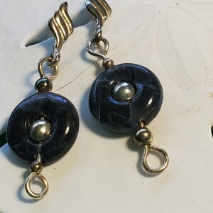 Sodalite and silver pierced earrings. Small sodalite donuts with a sterling silver bead suspended from a sterling silver flame.