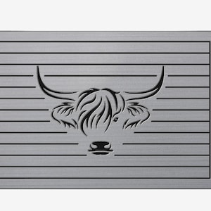 May include: A silver metal doormat with a black silhouette of a Highland cow head with long horns.