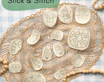 May include: A set of 15 iron-on patches featuring Christmas-themed designs, including a snowman, a candy cane, a Christmas tree, a stocking, a bell, and a wreath. The patches are on a beige burlap background.