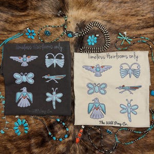 May include: Two t-shirts with turquoise and white insect and bird designs, and the text "Timeless Heirlooms only" and "The Wild Pony Co." Turquoise jewelry, including necklaces and earrings, is arranged around the shirts.