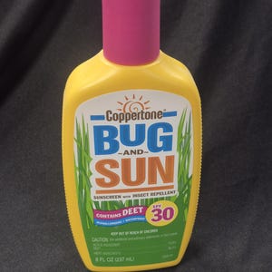 May include: Yellow Coppertone Bug and Sun sunscreen with a pink cap. The bottle contains insect repellent, SPF 30, and 8 fl oz (237 mL). The label has the words "Bug and Sun" in blue and orange.