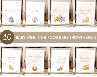 Könnte beinhalten: Zehn druckbare Babyparty-Schilder mit Winnie Puuh und seinen Freunden. Die Schilder sind in goldenen Rahmen mit weißem Hintergrund und zeigen verschiedene Sprüche wie "Babys sind süß, nimm dir einen Leckerbissen", "Geschenke, bitte bediene dich", "Geschenke und Bücher, danke für deine Großzügigkeit", "Windel-Tombola", "Ein bisschen Leckerbissen für deinen Bauch", "Mimosabar", "Zu Ehren von Mamas Bauch", und "Baby-Ratschläge".