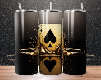 May include: Three stainless steel tumblers with a black and gold design. The design features a gold liquid splash with an ace of spades card in the center. The card is gold with a black spade.