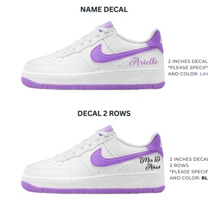 May include: White sneakers with purple accents, including the Nike swoosh and sole. The image shows two examples of custom decals: one with the name "Arielle" and another with "Mis 15 A&ntilde;os". Text on the image specifies decal size and color.