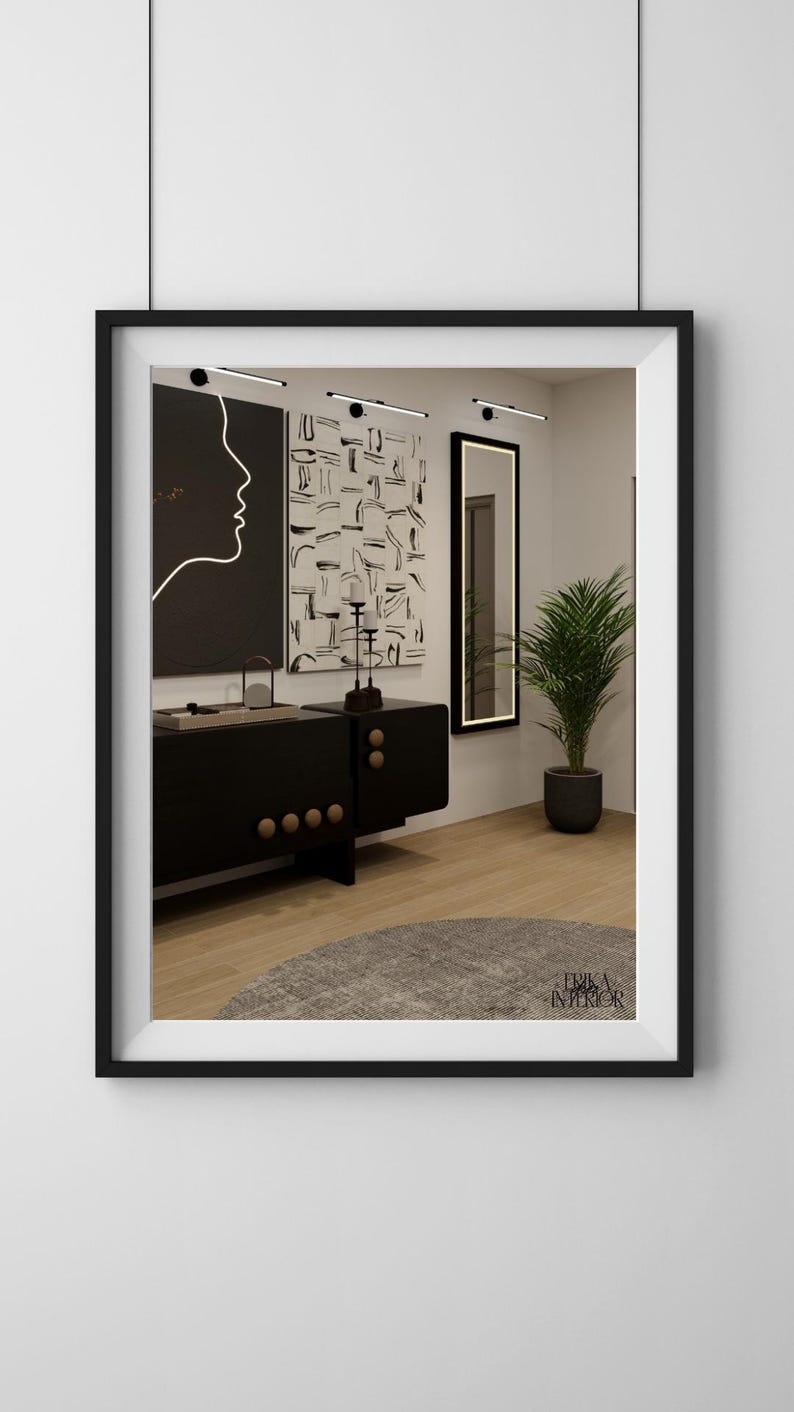 May include: Interior design with a black cabinet, wooden knobs, artwork, a mirror, and a potted plant. The artwork includes a black and white abstract design and a profile silhouette. The room has a modern aesthetic.