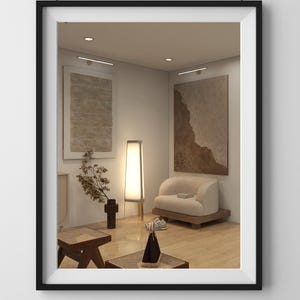 May include: Interior design scene framed in black. The mirror reflects a room with a beige sofa, artwork, a floor lamp, and a small wooden table. The room has a minimalist aesthetic with neutral tones.