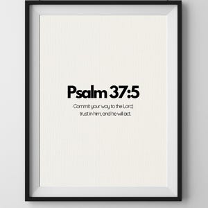 May include: A framed print featuring the text "Psalm 37:5" in bold black lettering. The print includes the quote, "Commit your way to the Lord; trust in him, and he will act." The frame is black, and the background is cream.