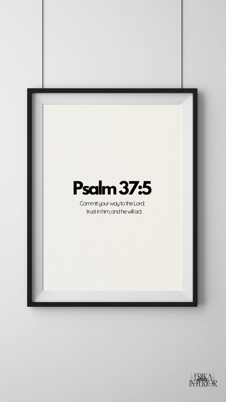 May include: A framed print featuring the text "Psalm 37:5" in bold black lettering. The print includes the quote, "Commit your way to the Lord; trust in him, and he will act." The frame is black, and the background is cream.