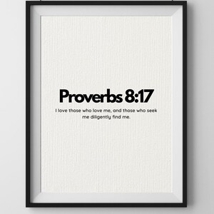 May include: A framed print featuring the text "Proverbs 8:17" in a bold black font. The quote "I love those who love me, and those who seek me diligently find me" is below. The background is off-white with a textured finish.