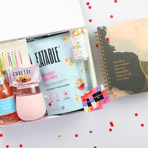 Birthday gift box with journal, birthday cake popcorn, gummies, champagne bears, candle tumbler, and party decor confetti