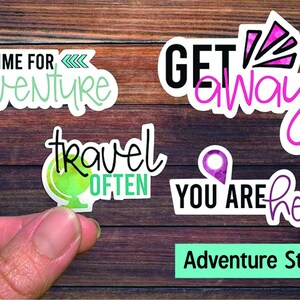 May include: Set of four adventure themed stickers. The stickers feature the phrases "Time for adventure", "Get away", "Travel often", and "You are here".