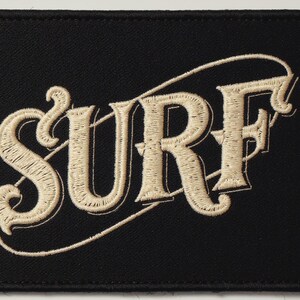 Surf Embroidered Patch Print framed in a beach-style living room setting