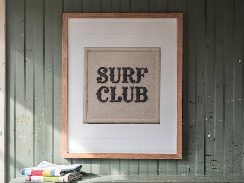 Surf Club Patch print in a Red Oak frame with a white mat, hanging above the cubbies in a mudroom.