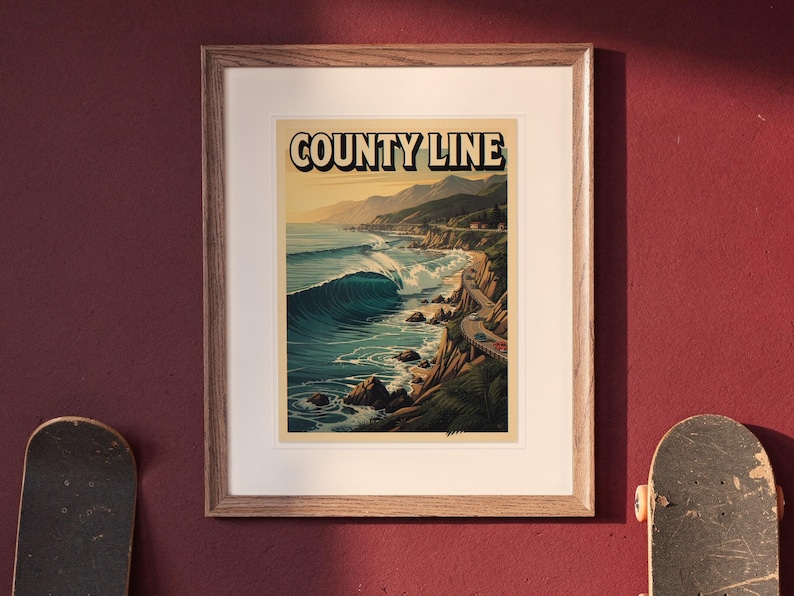 County Line Surf Travel Poster print in a Red Oak frame with a white mat, hanging above the desk in a green study.