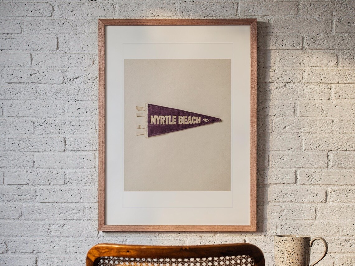 Myrtle Beach print in a Red Oak frame with a white mat, hanging above the desk in a home office.
