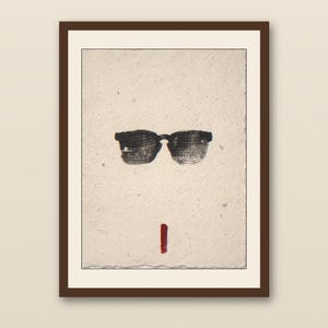 Sumi-e Wayfarer Sunglasses with Red Accent Print - walnut framed art print with cream mat on plaster wall