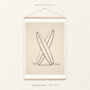 Crossed Surfboards Line oak hanger poster, 24 by 36 inches, with natural wood rails and a hanging cord.