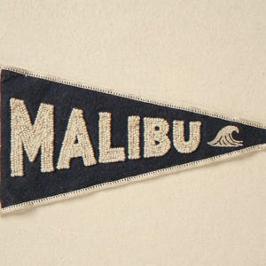 Malibu Vintage Surf Pennant Print framed in a coastal dining room setting