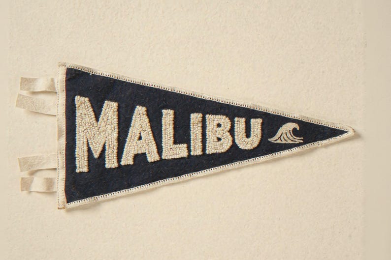 Malibu Vintage Surf Pennant Print framed in a coastal dining room setting