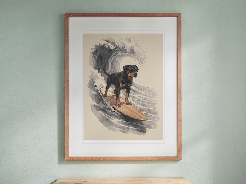 Rottweiler Surfing print in a Red Oak frame with a white mat, hanging above the desk in a kids' room.