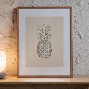 Pineapple Line print in a Red Oak frame with a white mat, leaning on the bench against the wall in a japandi living room.