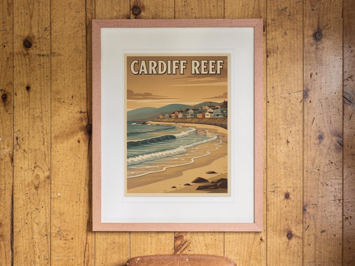 Cardiff Reef Surf Travel Poster print in a Red Oak frame with a white mat, hanging on the paneling in a 1960s den.