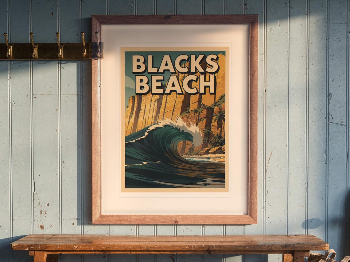 Blacks Beach Surf Travel Poster print in a Red Oak frame with a white mat, hanging above the bench in a beach cottage entryway.