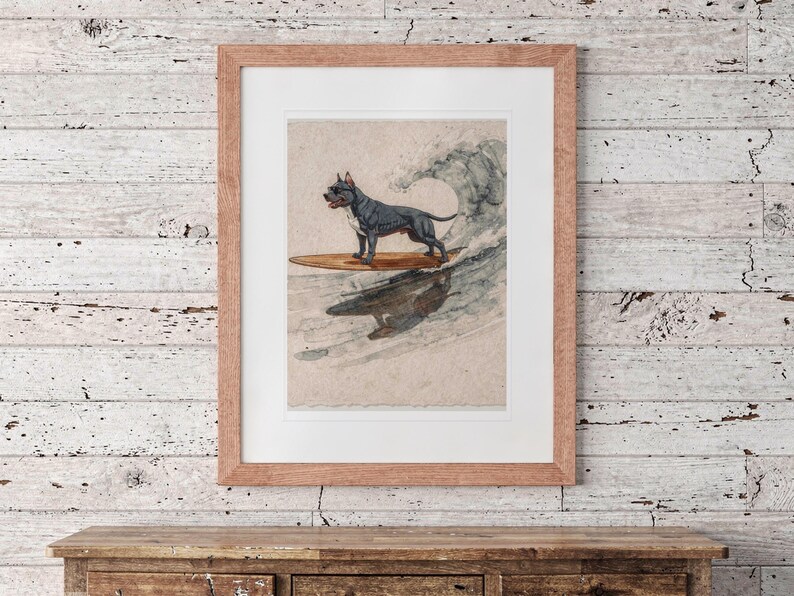 Pit Bull Surfing printable art, shown printed in a Red Oak frame with a white mat, hanging above the dresser in a surf shack bedroom.