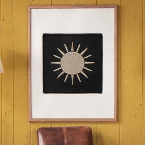 Sun Patch print in a Red Oak frame with a white mat, hanging on the paneling in a 1960s den.
