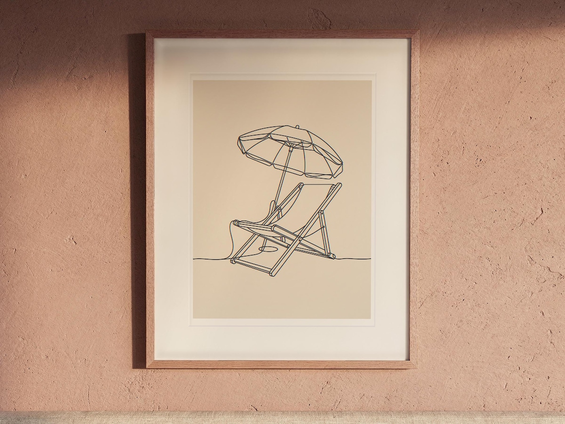 Beach Chair and Umbrella Line print in a Red Oak frame with a white mat, hanging above the headboard in a calm bedroom.