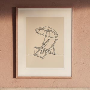 Beach Chair and Umbrella Line print in a Red Oak frame with a white mat, hanging above the headboard in a calm bedroom.