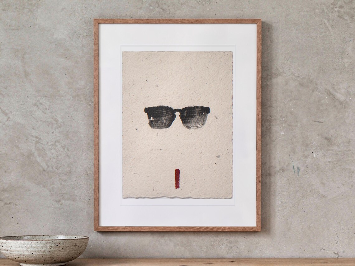 Sunglasses Ink Style print in a Red Oak frame with a white mat, hanging above the console in a japandi living room.