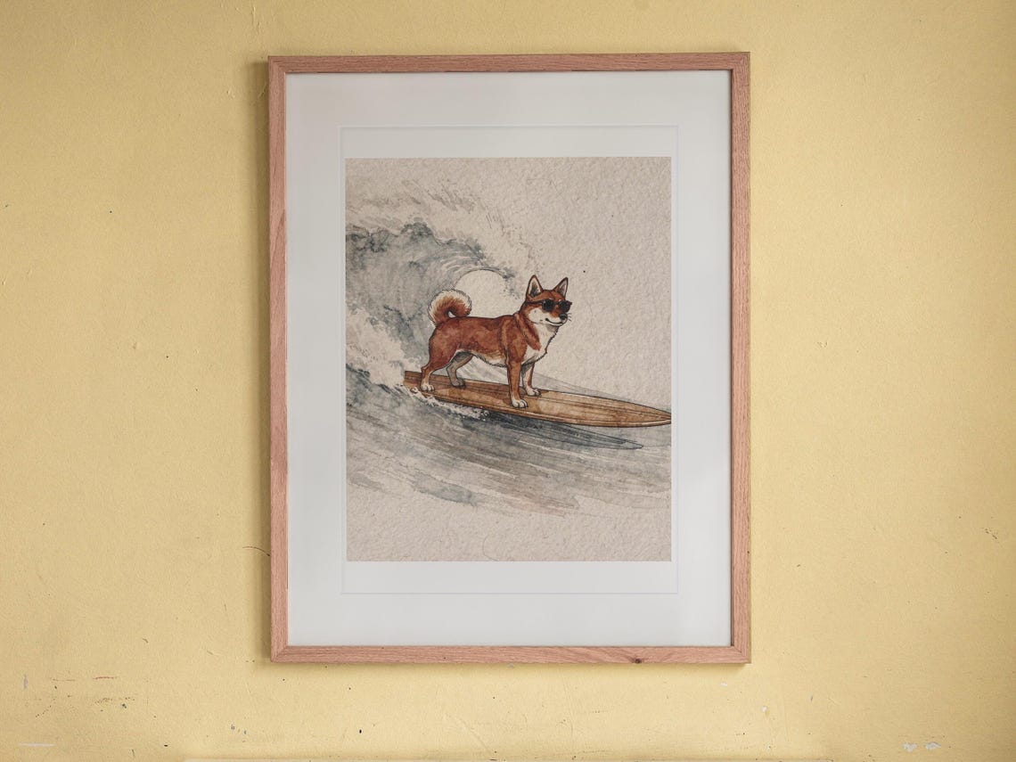 Shiba Inu Surfing print in a Red Oak frame with a white mat, hanging above the bookshelf in a kids' room.