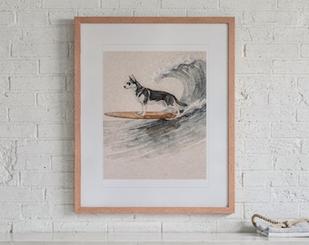 May include: A framed watercolor print featuring a black and white husky dog wearing sunglasses while standing on a brown surfboard riding a large ocean wave. The artwork is enclosed in a light-colored wooden frame with a white mat border.