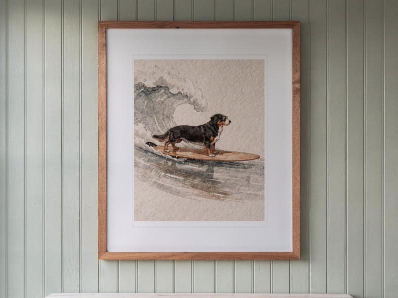 Bernese Mountain Dog Surfing print in a Red Oak frame with a white mat, hanging above the console in a beach cottage entryway.