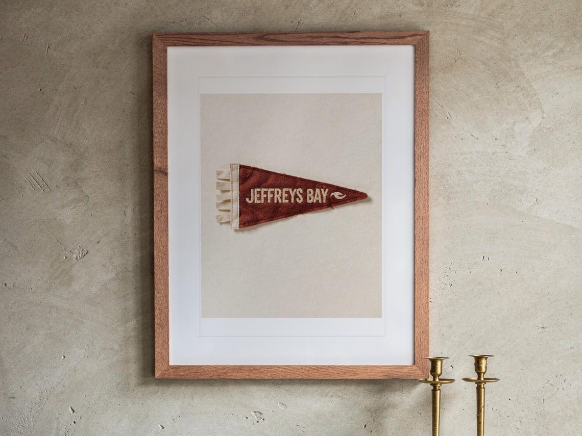 Jeffreys Bay print in a Red Oak frame with a white mat, hanging above the buffet in a dining room.