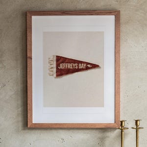 Jeffreys Bay print in a Red Oak frame with a white mat, hanging above the buffet in a dining room.