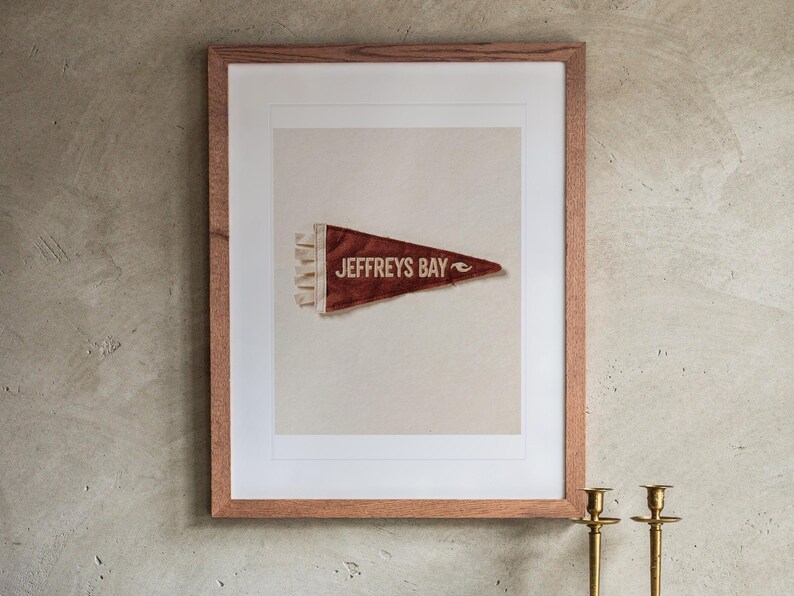 Jeffreys Bay print in a Red Oak frame with a white mat, hanging above the buffet in a dining room.