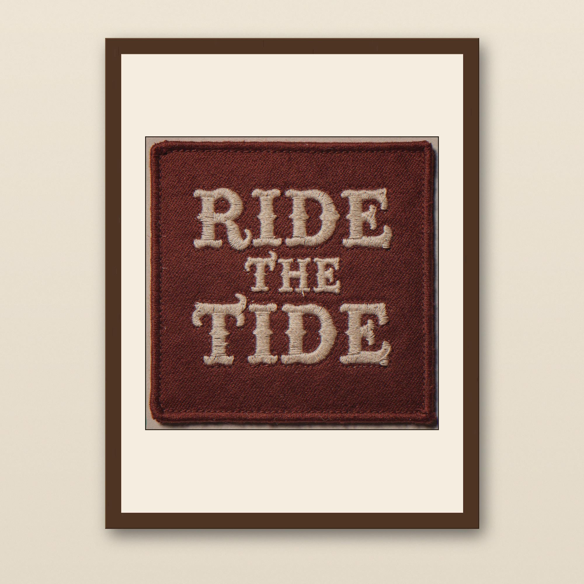 Ride the Tide Embroidered Patch Print - walnut framed art print with cream mat on plaster wall