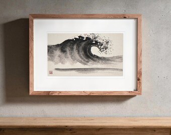 May include: A framed ink wash painting on paper depicting a large, curling ocean wave in shades of black and grey. The artwork features a single red square seal in the bottom left corner and is enclosed in a light brown wooden frame.