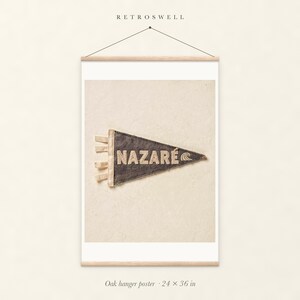 Nazaré Surf Pennant oak hanger poster, 24 by 36 inches, with natural wood rails and a hanging cord.
