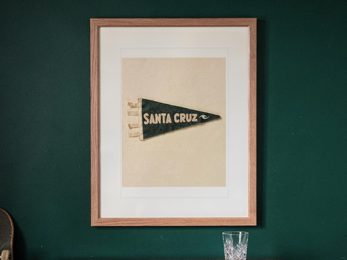 Santa Cruz print in a Red Oak frame with a white mat, hanging above the cabinet in a game room.